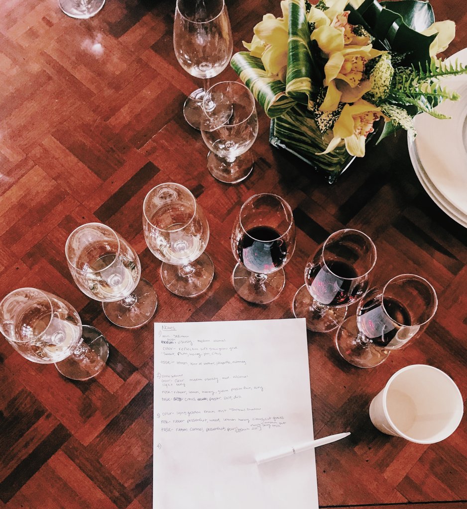 A glass of wine being tasted at AJA Vineyards