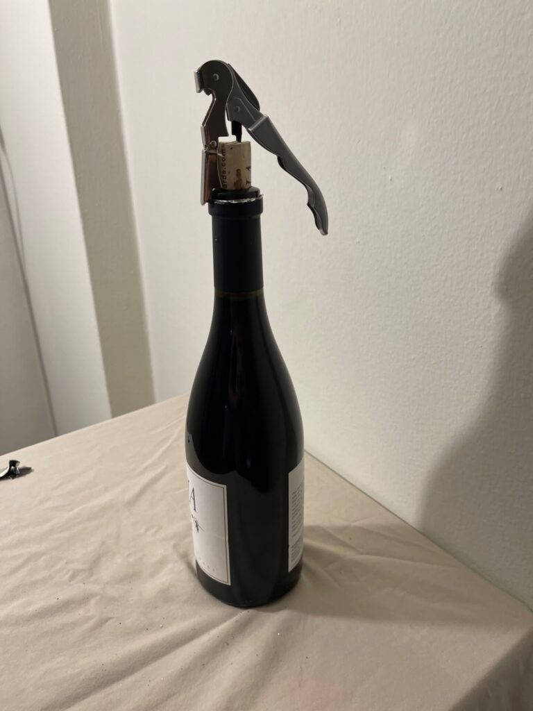 Opening a bottle of AJA Vineyards wine with a waiter's corkscrew