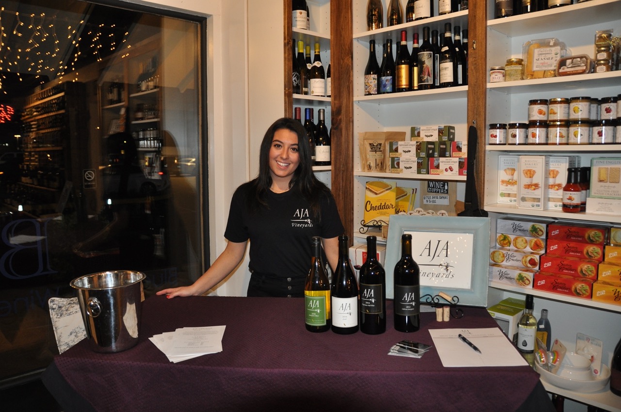 A glass of wine being poured at AJA Vineyards