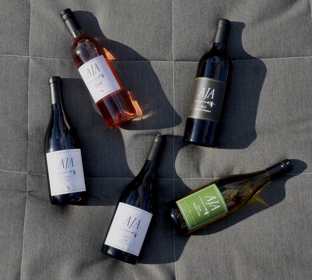 Bottles of AJA Vineyards wine with cork and screw cap enclosures